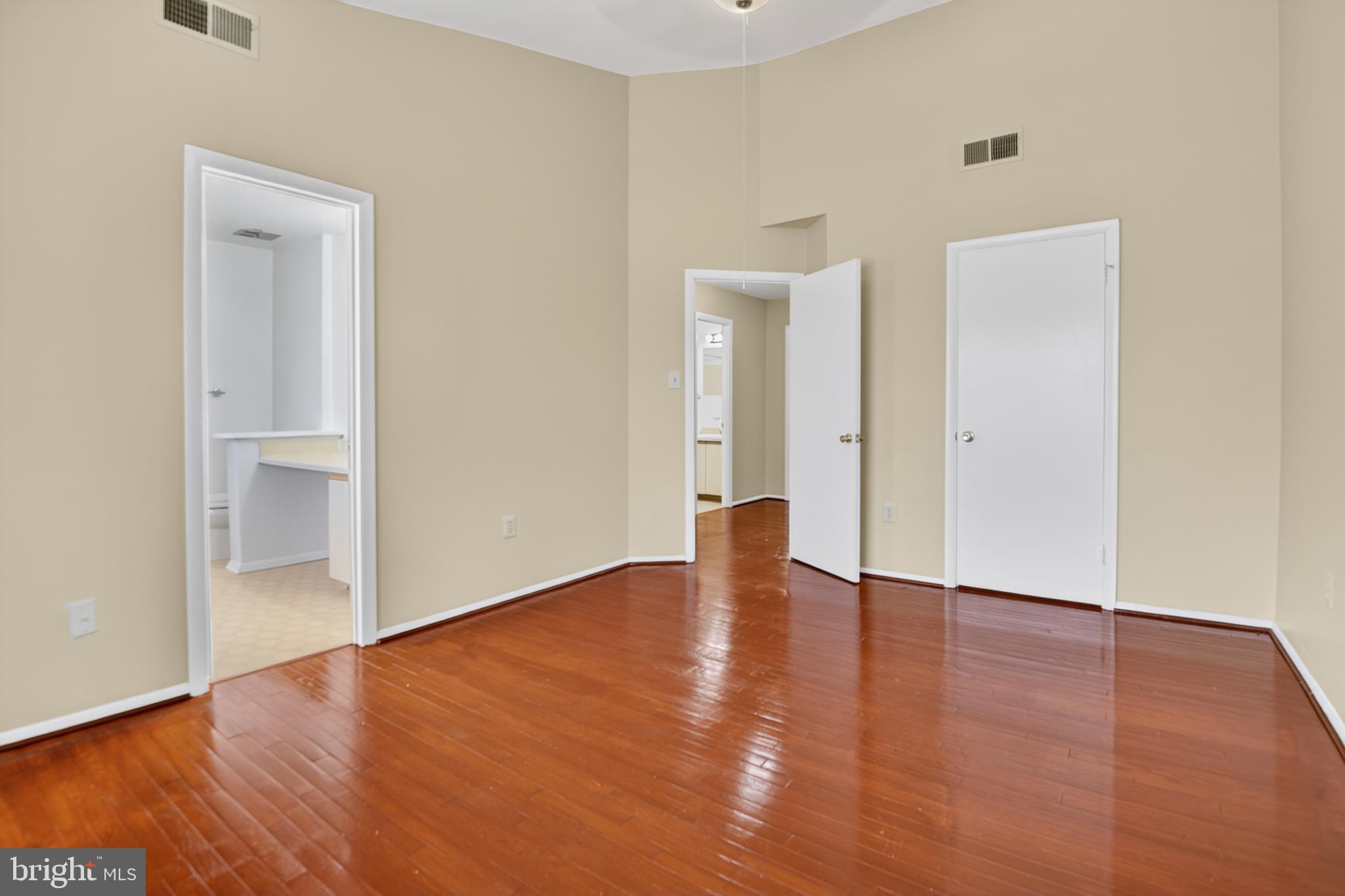 18314 Hallmark Court Gaithersburg, MD 20879 - Photo 20 of 26 a view of an empty room with wooden floor and a window