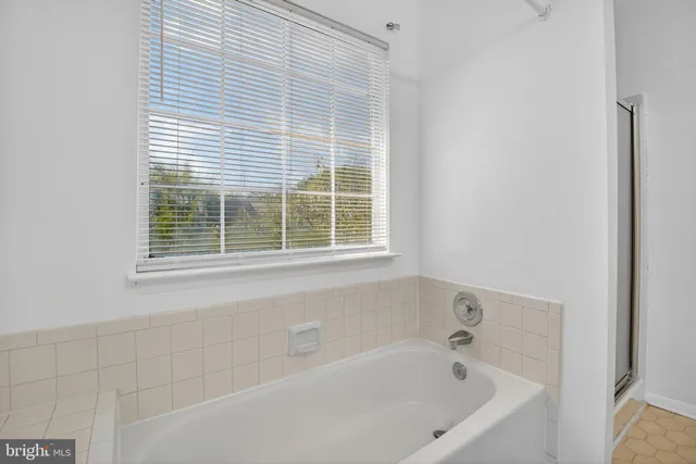 a white bath tub sitting next to a window