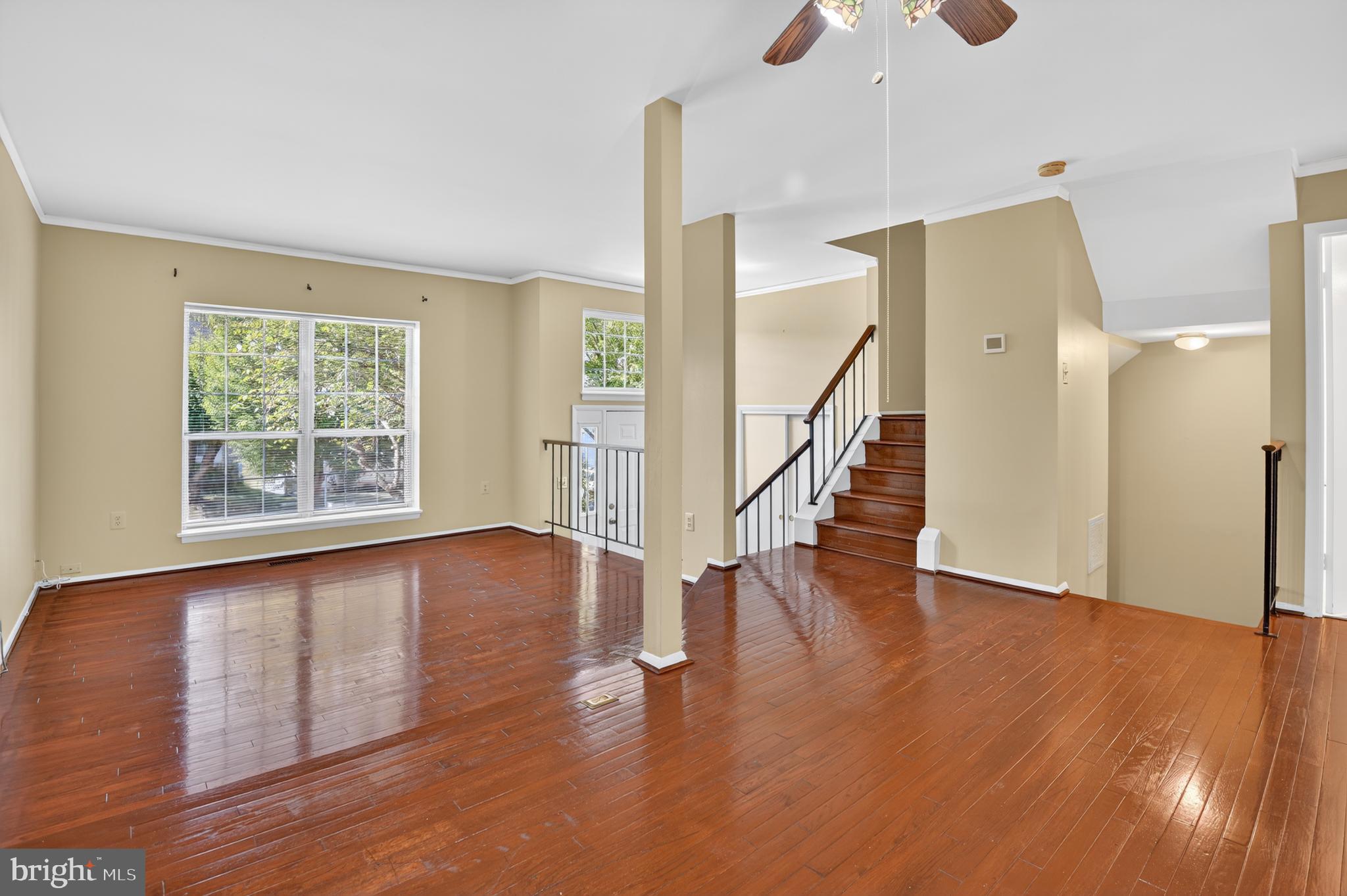18314 Hallmark Court Gaithersburg, MD 20879 - Photo 3 of 26 a view of an empty room with wooden floor and a window