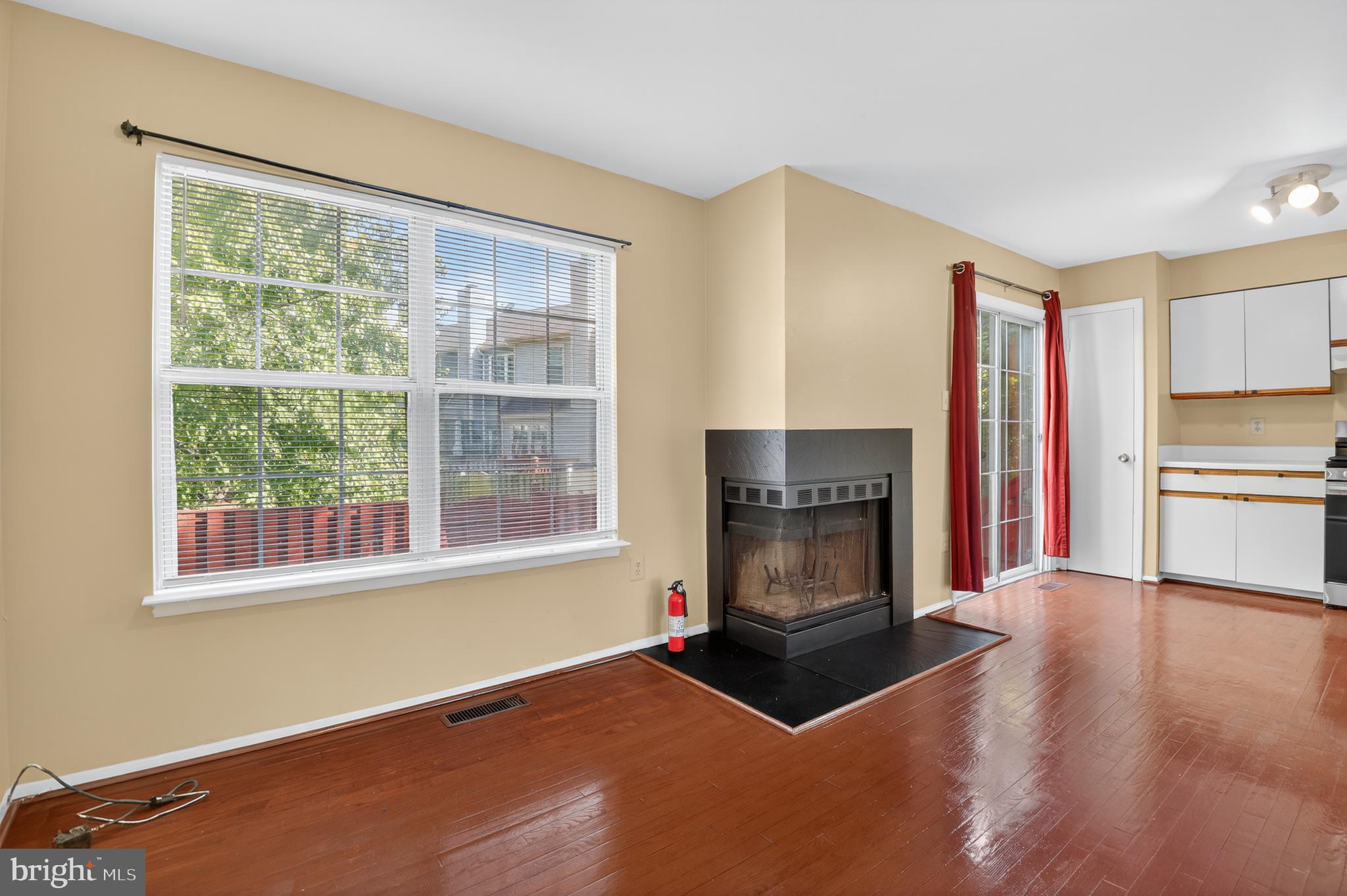 18314 Hallmark Court Gaithersburg, MD 20879 - Photo 8 of 26 a living room with a fireplace with wooden floor