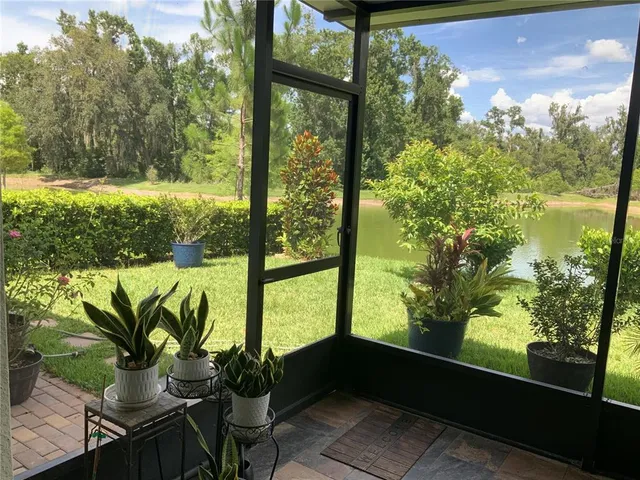 a vase of flowers sitting on a table with wooden floor