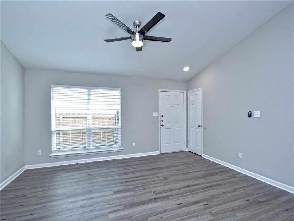 2302 Fuzz Fairway, Unit B Austin, TX 78728 - Photo 10 of 27 Front living area. High ceiling. New ceiling fan with remote control. Big picture window lets in an abundance of natural light.