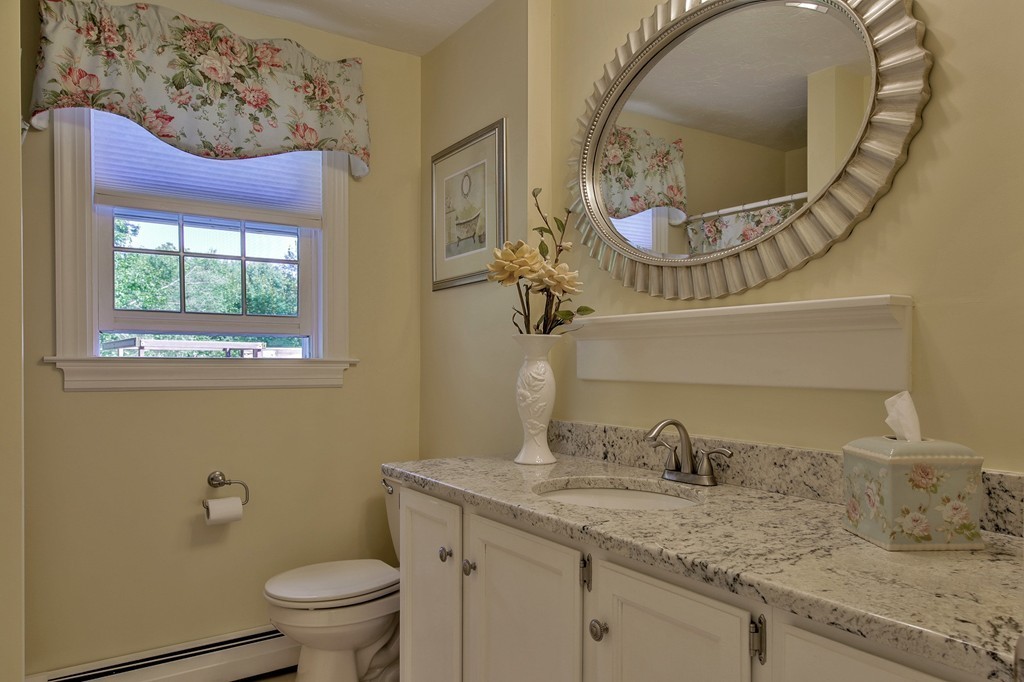 102 Fitzpatrick Road Grafton, MA 01519 - Photo 13 of 25 a bathroom with a granite countertop toilet sink and mirror