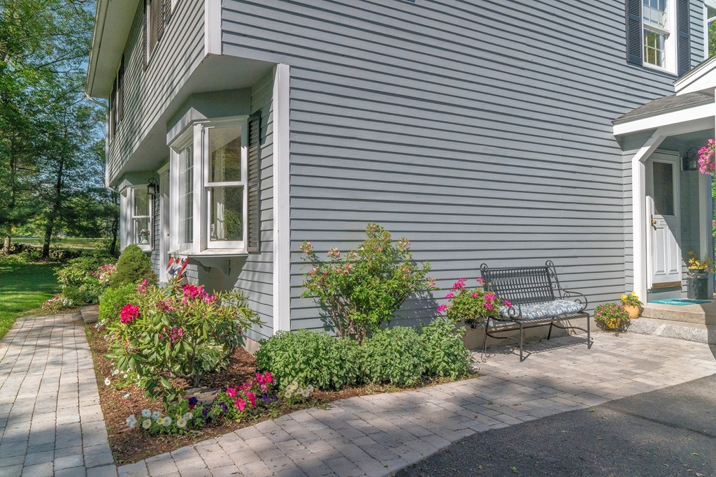 102 Fitzpatrick Road Grafton, MA 01519 - Photo 3 of 25 a view of a house with a yard and a garden