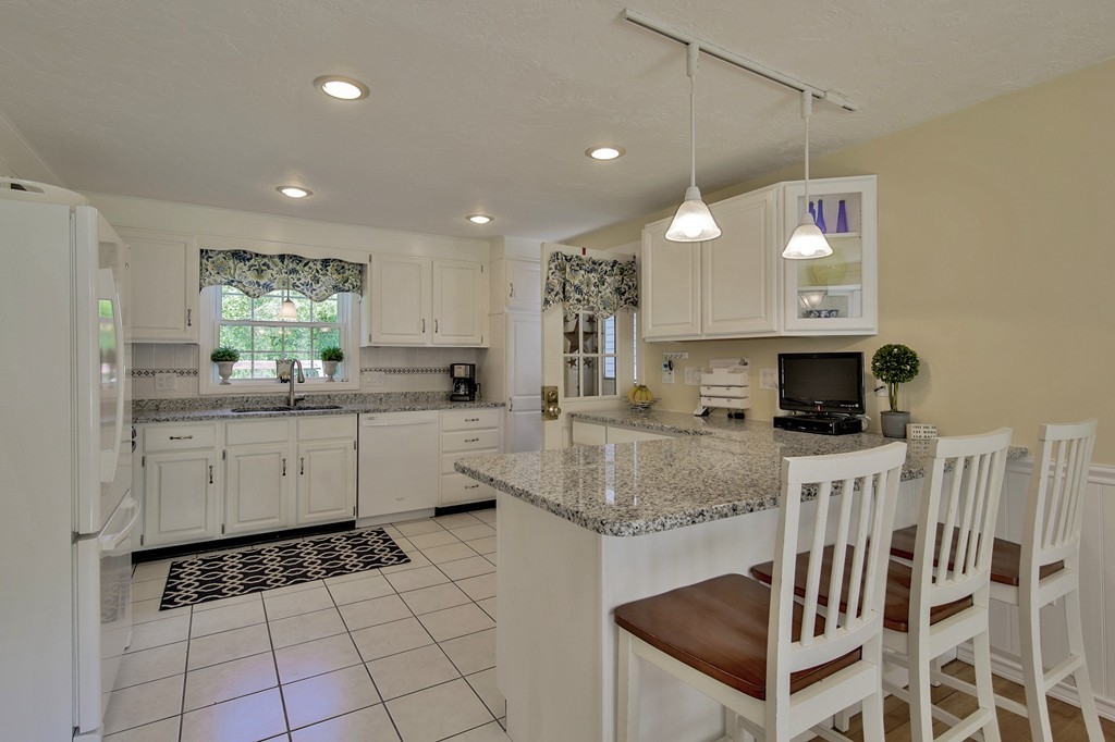 102 Fitzpatrick Road Grafton, MA 01519 - Photo 7 of 25 a kitchen with stainless steel appliances granite countertop a stove a sink and a microwave