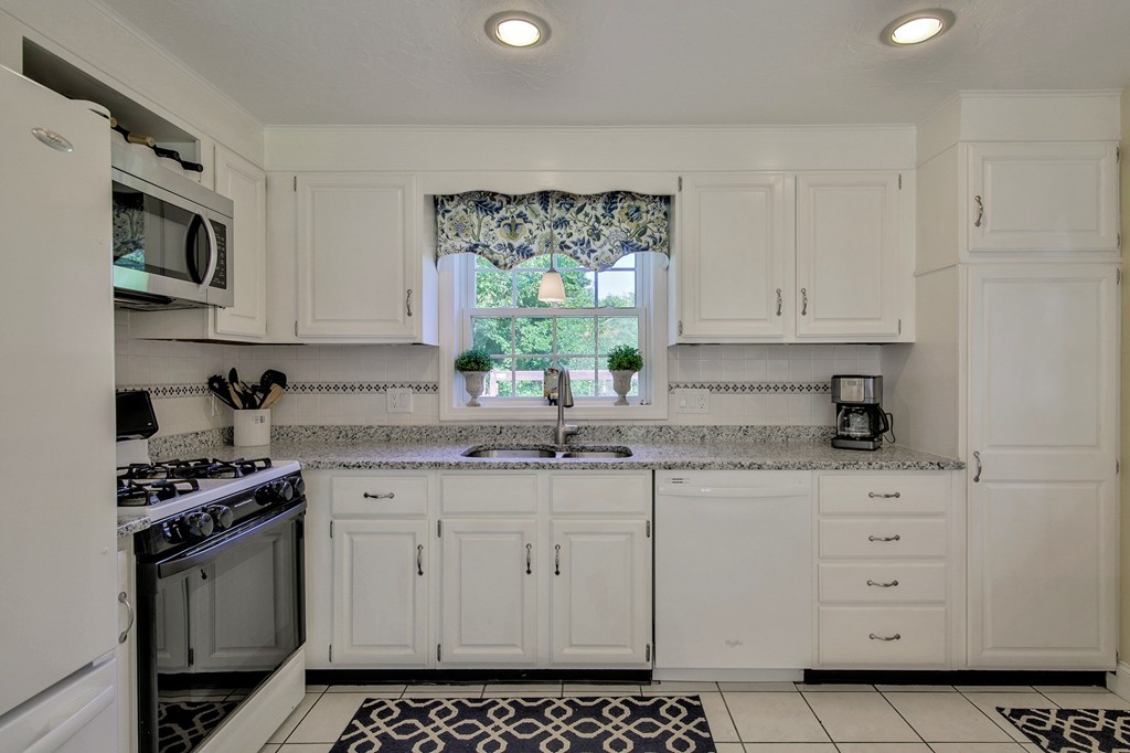 102 Fitzpatrick Road Grafton, MA 01519 - Photo 8 of 25 a kitchen with stainless steel appliances a stove a sink and a cabinets