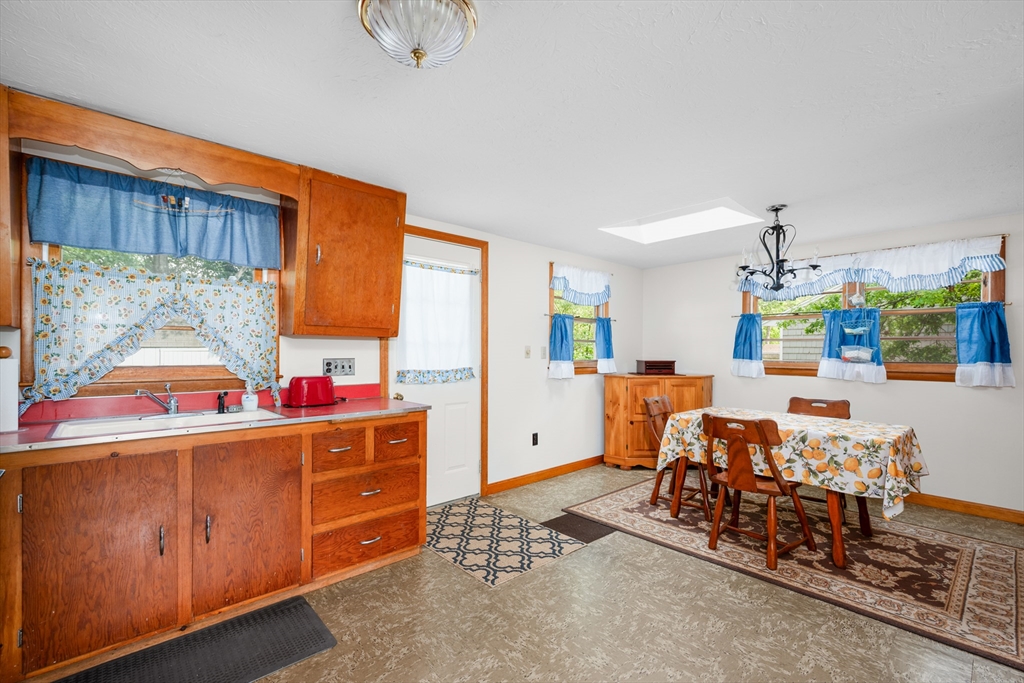 64 Uncle Percy's Road Mashpee, MA 02649 - Photo 11 of 33 a kitchen with stainless steel appliances kitchen island granite countertop a stove and a white cabinets