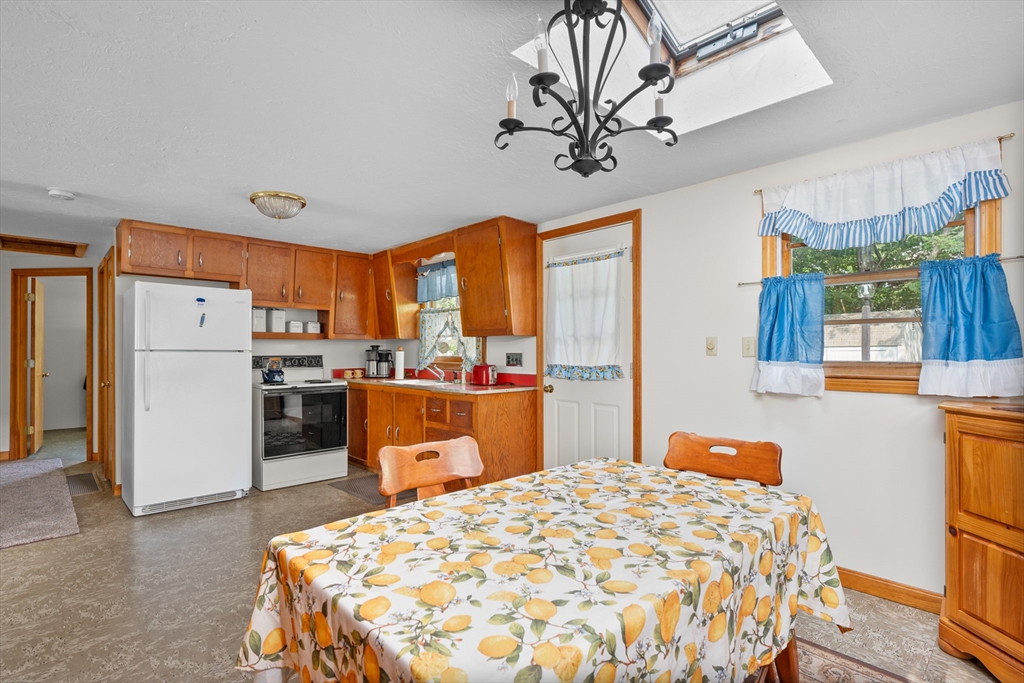 64 Uncle Percy's Road Mashpee, MA 02649 - Photo 14 of 33 a bedroom with a bed dresser and a large window
