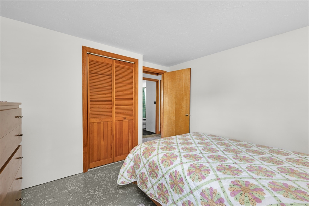 64 Uncle Percy's Road Mashpee, MA 02649 - Photo 16 of 33 a bedroom with a bed and a closet