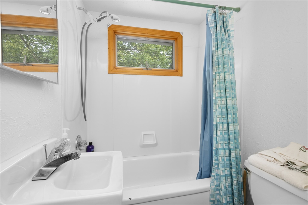 64 Uncle Percy's Road Mashpee, MA 02649 - Photo 19 of 33 a bathroom with a sink and a bathtub