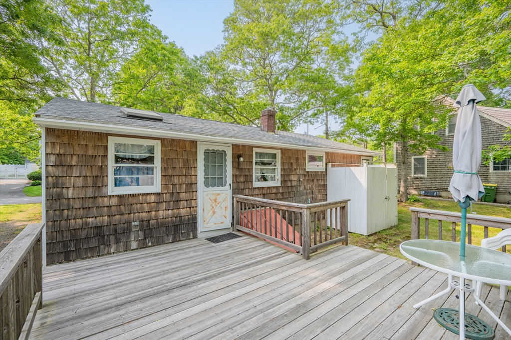 64 Uncle Percy's Road Mashpee, MA 02649 - Photo 25 of 33 a view of house with deck outdoor seating and wooden floor