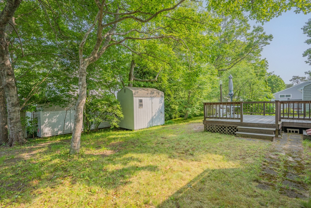 64 Uncle Percy's Road Mashpee, MA 02649 - Photo 26 of 33 a view of a backyard with a small cabin