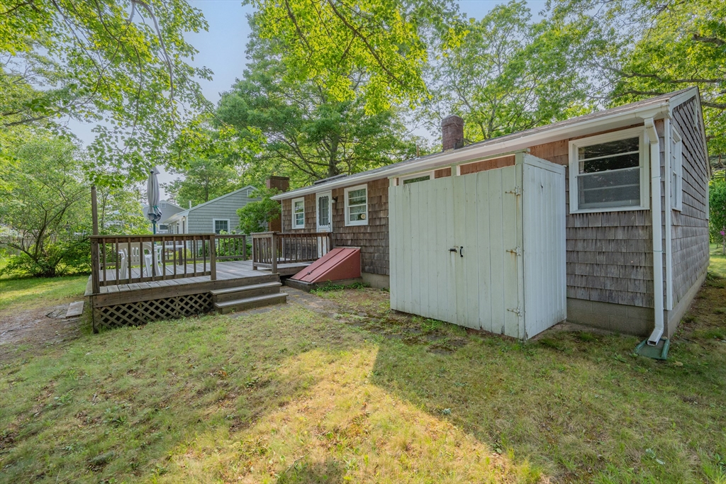64 Uncle Percy's Road Mashpee, MA 02649 - Photo 27 of 33 a view of backyard with wooden fence and a bench