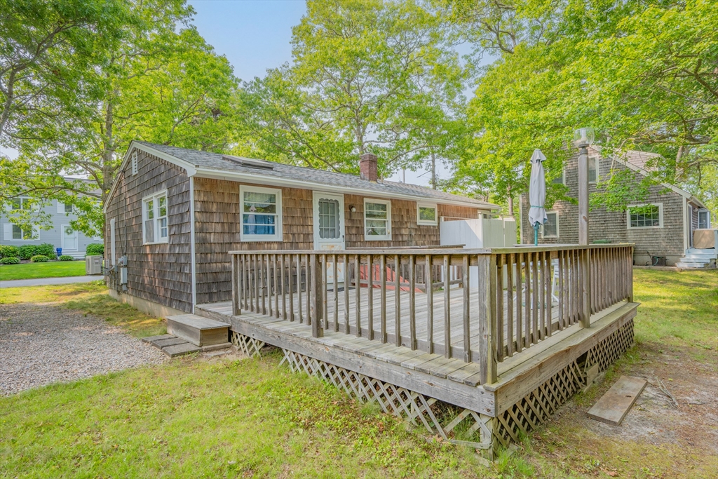 64 Uncle Percy's Road Mashpee, MA 02649 - Photo 29 of 33 a view of backyard with deck and a garden
