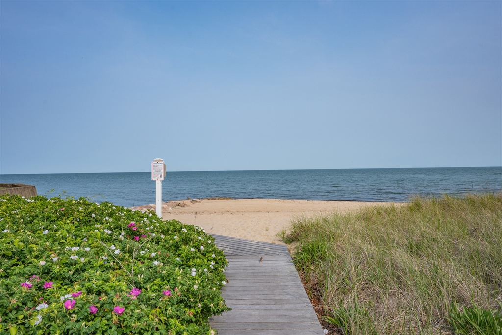 64 Uncle Percy's Road Mashpee, MA 02649 - Photo 32 of 33 a view of a lake with a building in the background