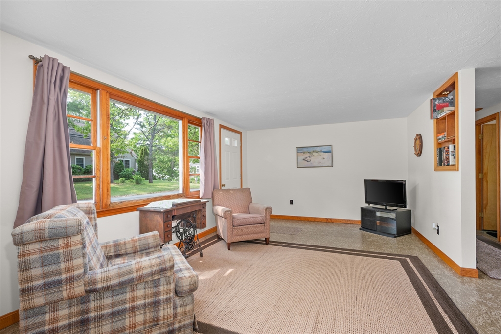 64 Uncle Percy's Road Mashpee, MA 02649 - Photo 6 of 33 a bedroom with furniture and a flat screen tv