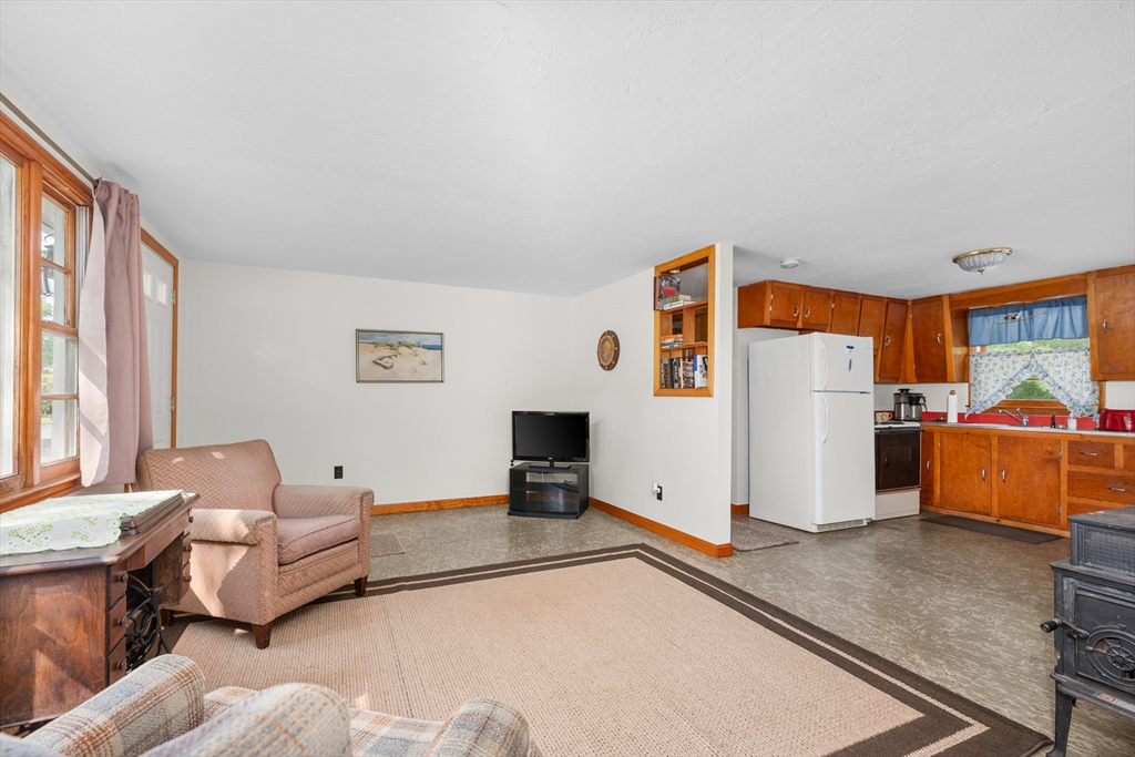 64 Uncle Percy's Road Mashpee, MA 02649 - Photo 7 of 33 a living room with furniture and a flat screen tv