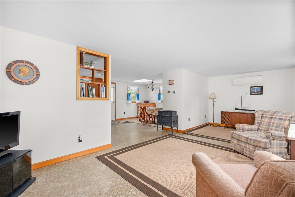 64 Uncle Percy's Road Mashpee, MA 02649 - Photo 8 of 33 a living room with furniture and a flat screen tv