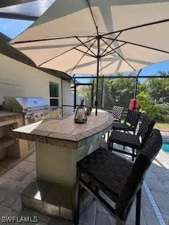 a kitchen with a stove a table and chairs in it
