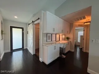 a kitchen with a refrigerator and a sink