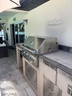 a stove top oven sitting inside of a kitchen