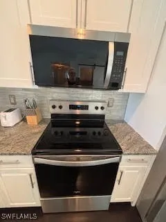 a stove top oven sitting inside of a kitchen