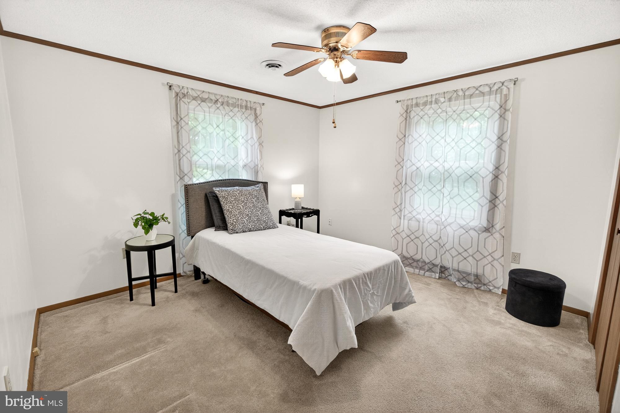 5601 Woodville Road Mount Airy, MD 21771 - Photo 29 of 54 a bedroom with a bed and a chandelier