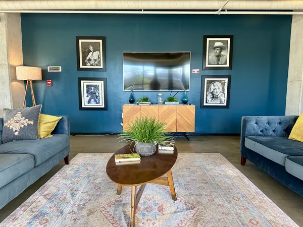 a living room with furniture and a potted plant
