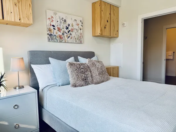 a bedroom with a bed and wall painting