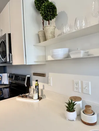 a kitchen with a stove a microwave and cabinets