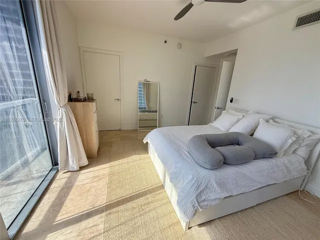 a bedroom with a bed and a couch