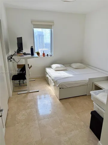 a bedroom with a bed and a desk