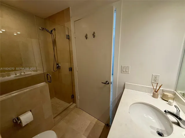 a bathroom with a sink and shower