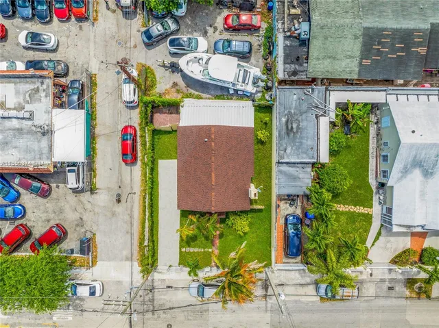 an aerial view of residential house with outdoor space and seating area