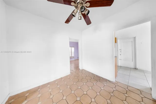 a view of a hallway with a chandelier fan and windows