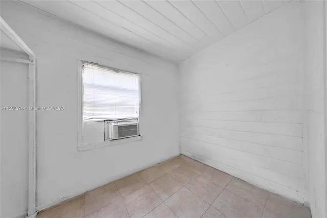 a kitchen with a stove top oven and cabinets