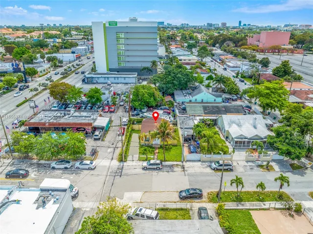 an aerial view of residential houses with outdoor space and street view