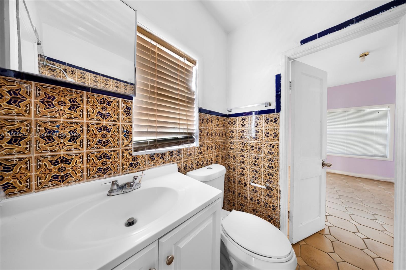 2728 Northwest 3rd Street Miami, FL 33125 - Photo 31 of 33 a bathroom with a sink toilet and shower