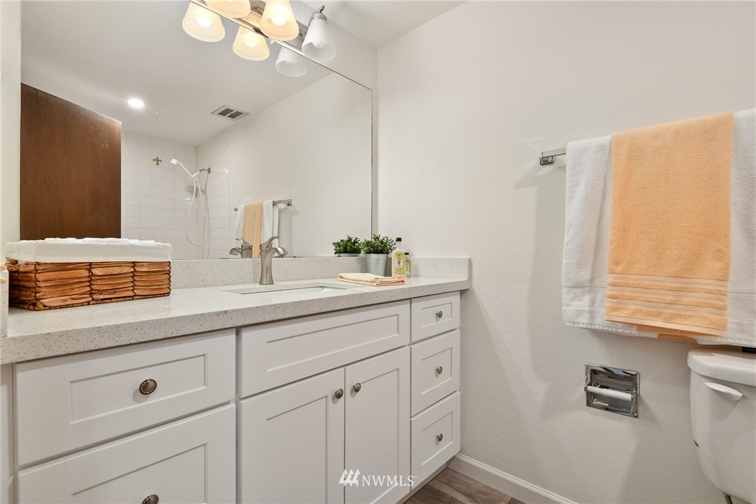4908 200th Street Southeast Bothell, WA 98012 - Photo 13 of 29 a bathroom with a sink a large mirror and vanity