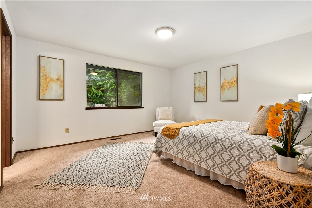 4908 200th Street Southeast Bothell, WA 98012 - Photo 16 of 29 a bedroom with a bed and wooden floor