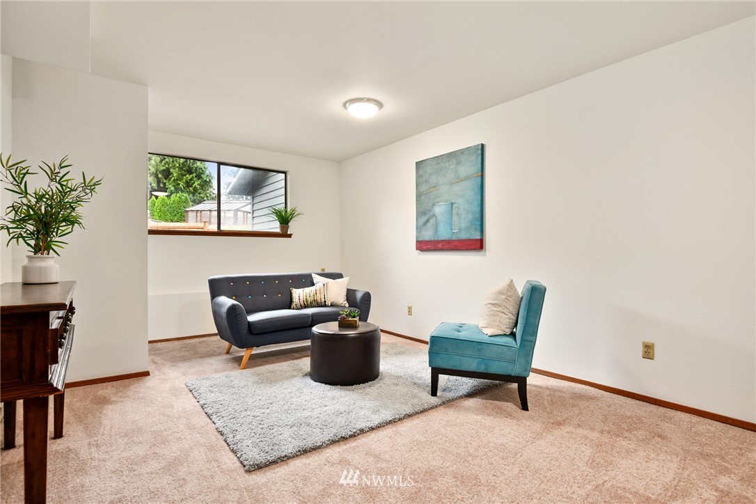 4908 200th Street Southeast Bothell, WA 98012 - Photo 18 of 29 a living room with furniture and a window