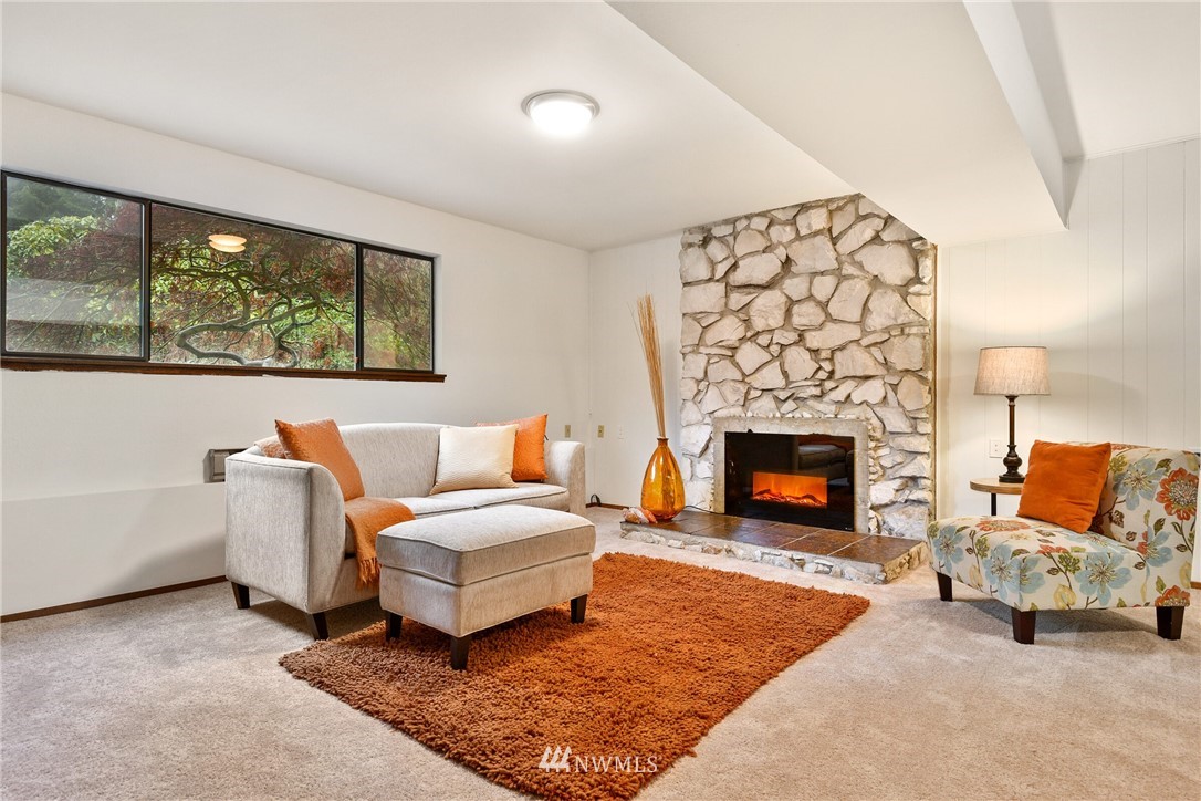 4908 200th Street Southeast Bothell, WA 98012 - Photo 21 of 29 a living room with furniture and a fireplace