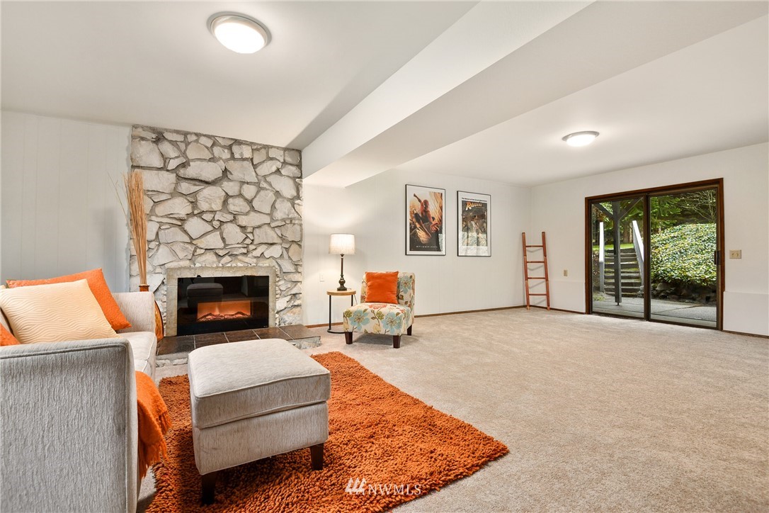4908 200th Street Southeast Bothell, WA 98012 - Photo 22 of 29 a living room with furniture and a fireplace