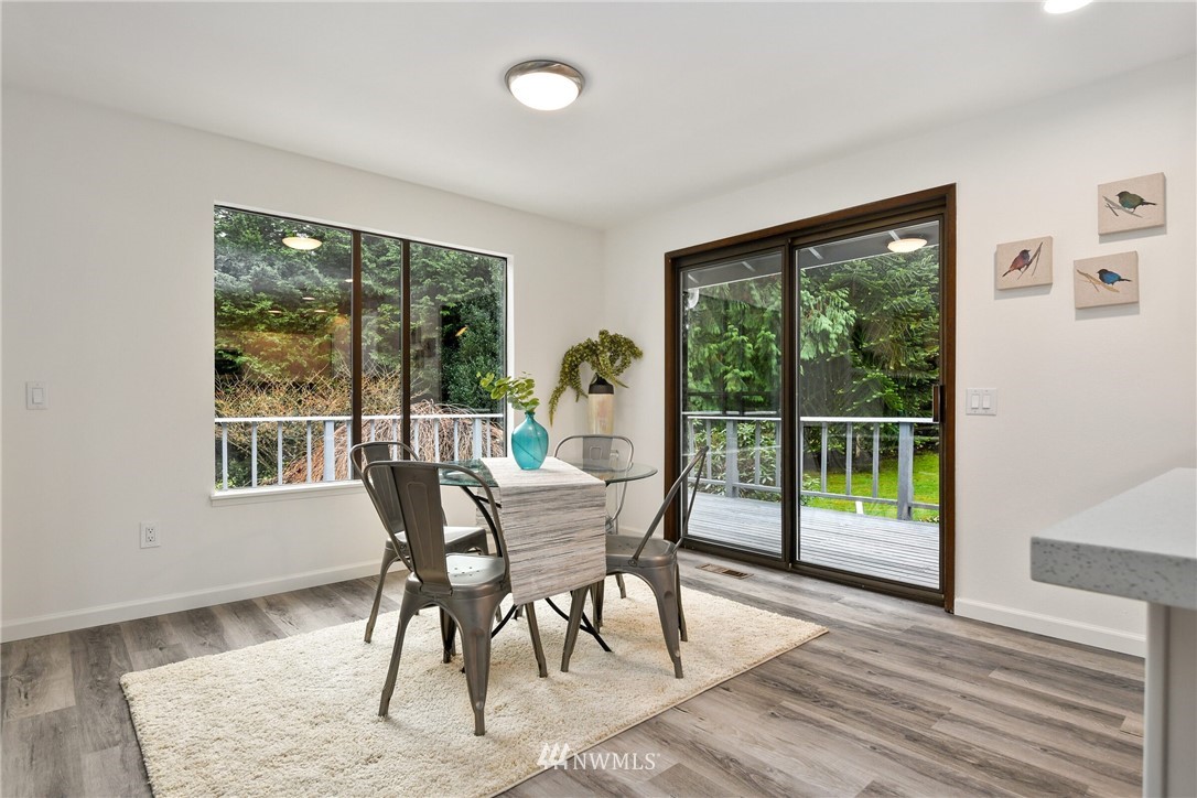 4908 200th Street Southeast Bothell, WA 98012 - Photo 8 of 29 a dining room with wooden floor and windows