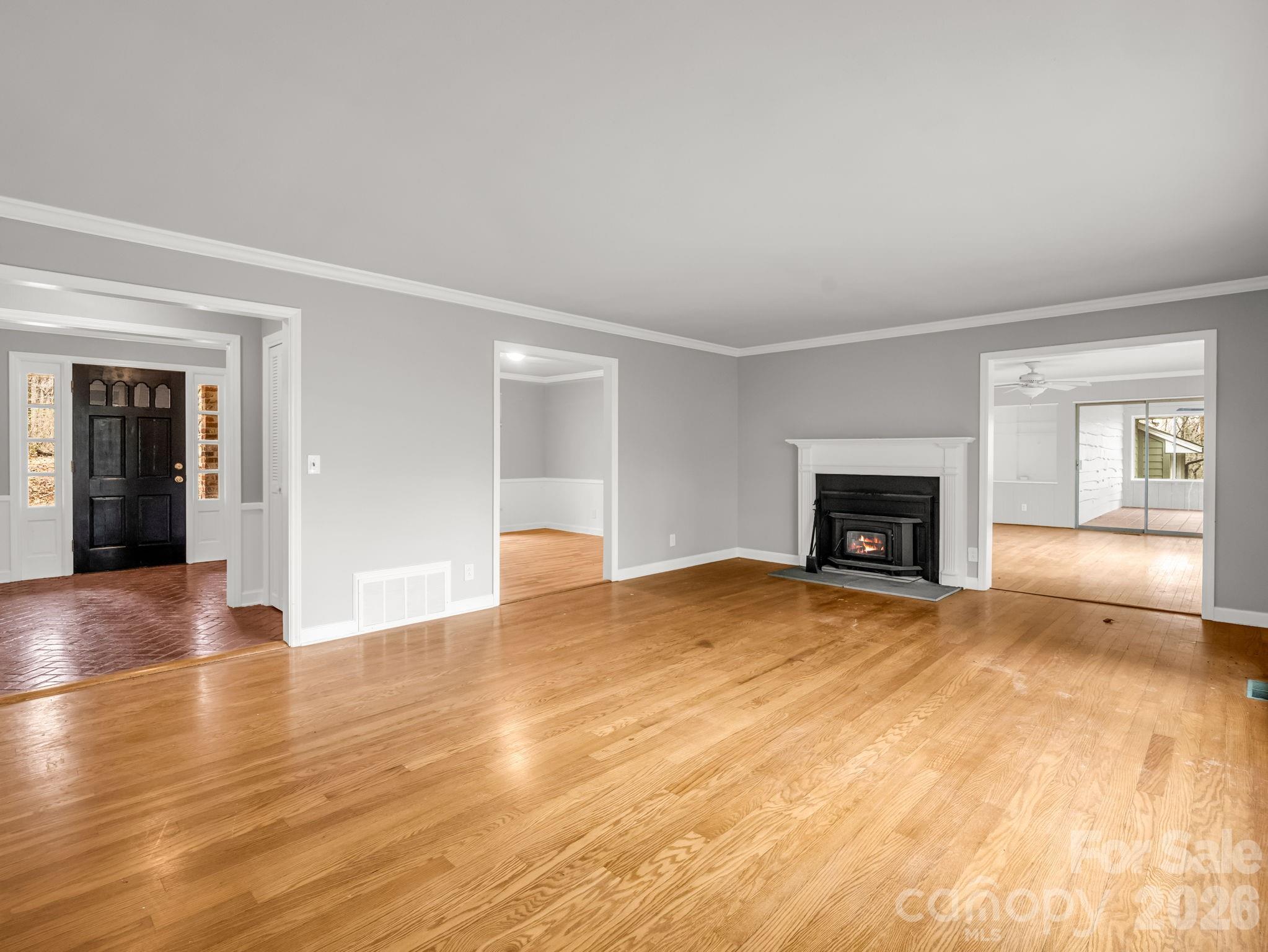 117 Hummingbird Lane Columbus, NC 28722 - Photo 13 of 32 a view of empty room with wooden floor and fireplace