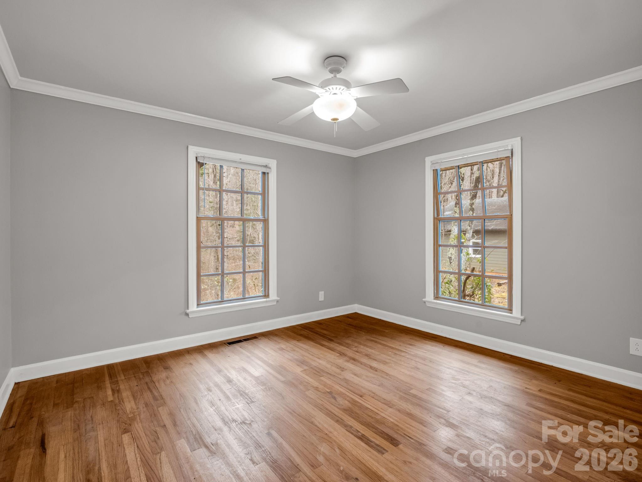 117 Hummingbird Lane Columbus, NC 28722 - Photo 21 of 32 a view of an empty room with wooden floor and a window