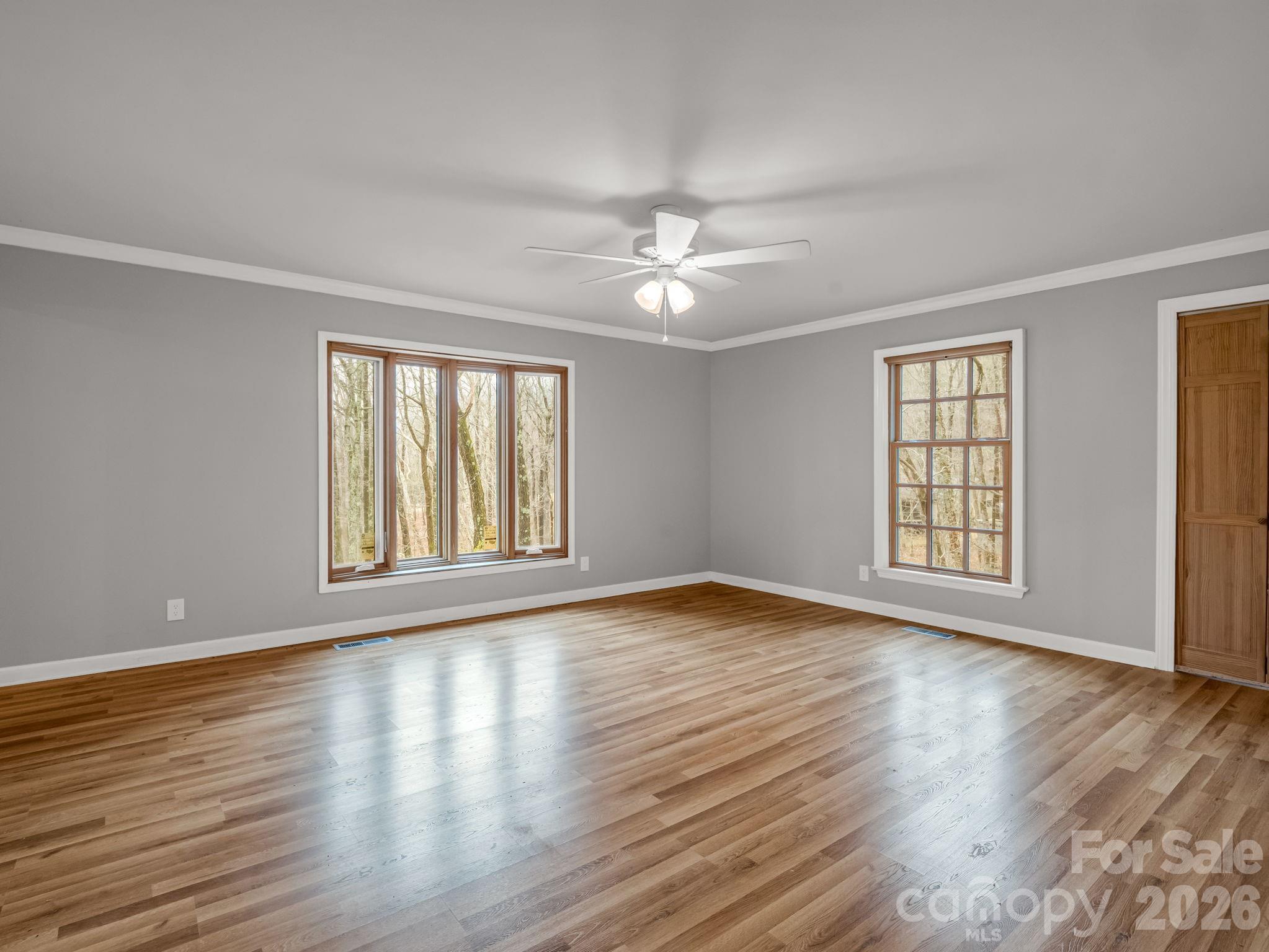 117 Hummingbird Lane Columbus, NC 28722 - Photo 22 of 32 a view of an empty room with wooden floor and a window