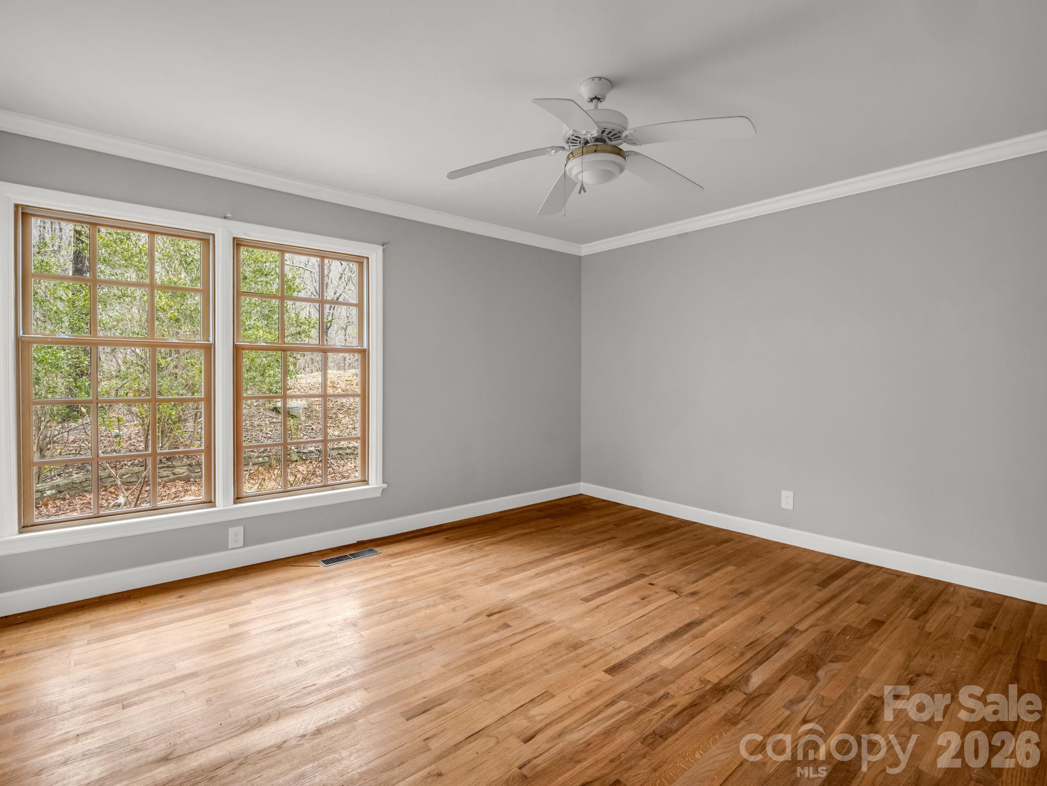 117 Hummingbird Lane Columbus, NC 28722 - Photo 24 of 32 a view of an empty room with wooden floor and a window