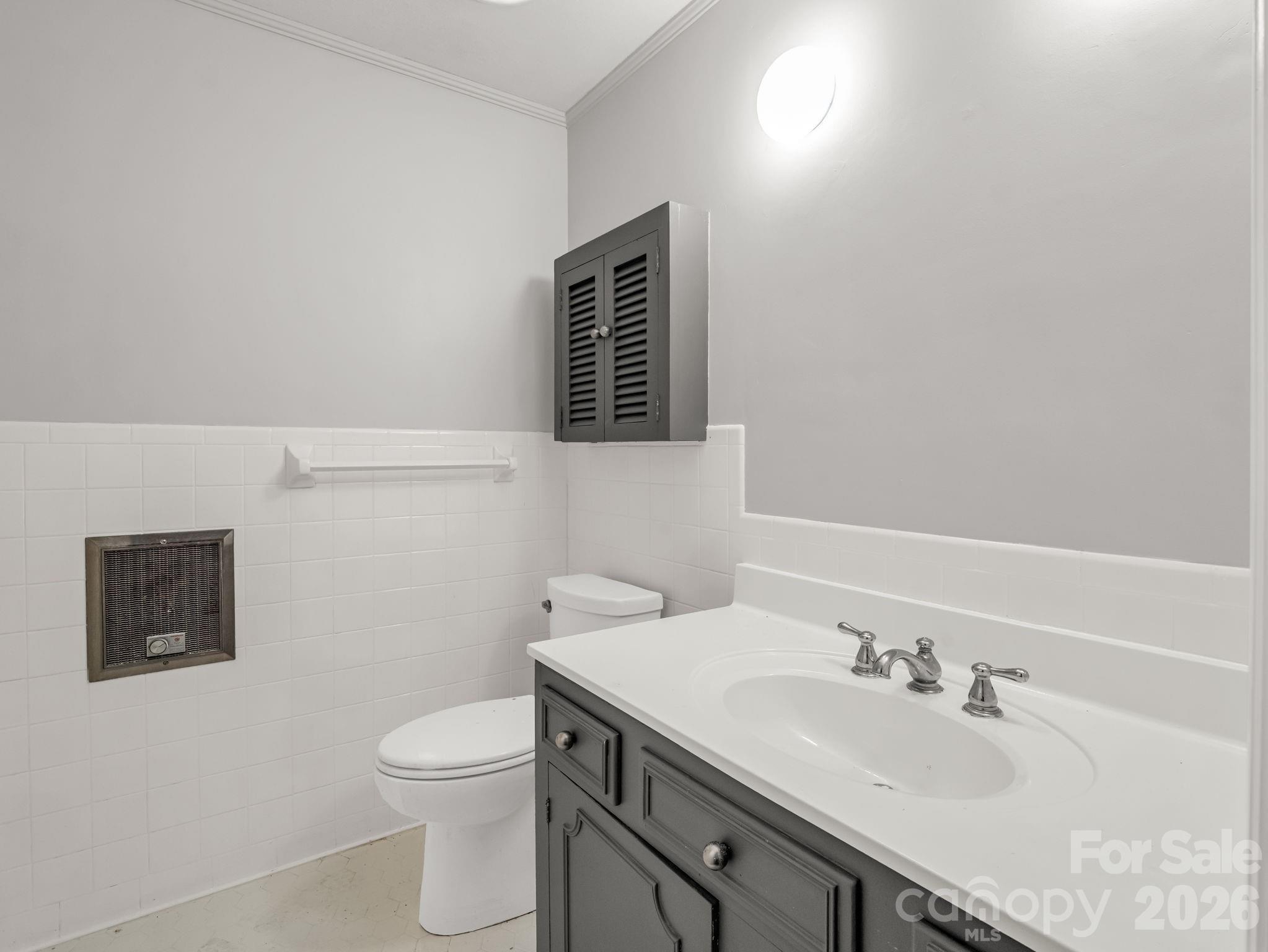 117 Hummingbird Lane Columbus, NC 28722 - Photo 26 of 32 a bathroom with a sink a toilet and mirror