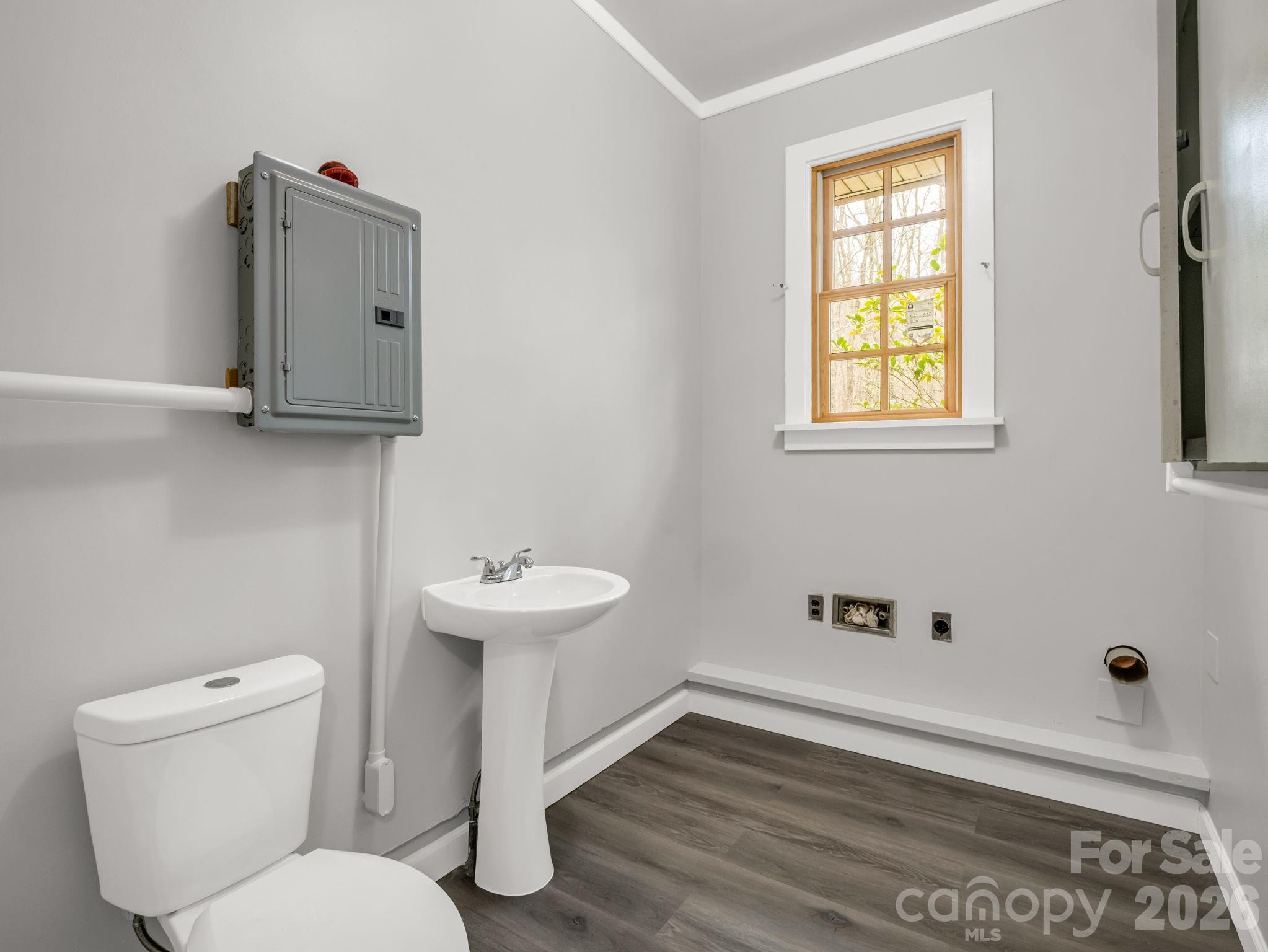 117 Hummingbird Lane Columbus, NC 28722 - Photo 27 of 32 a bathroom with a toilet sink and mirror